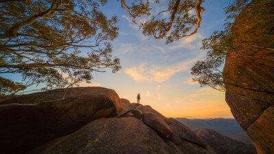 Man standing on rocks looking out at the view